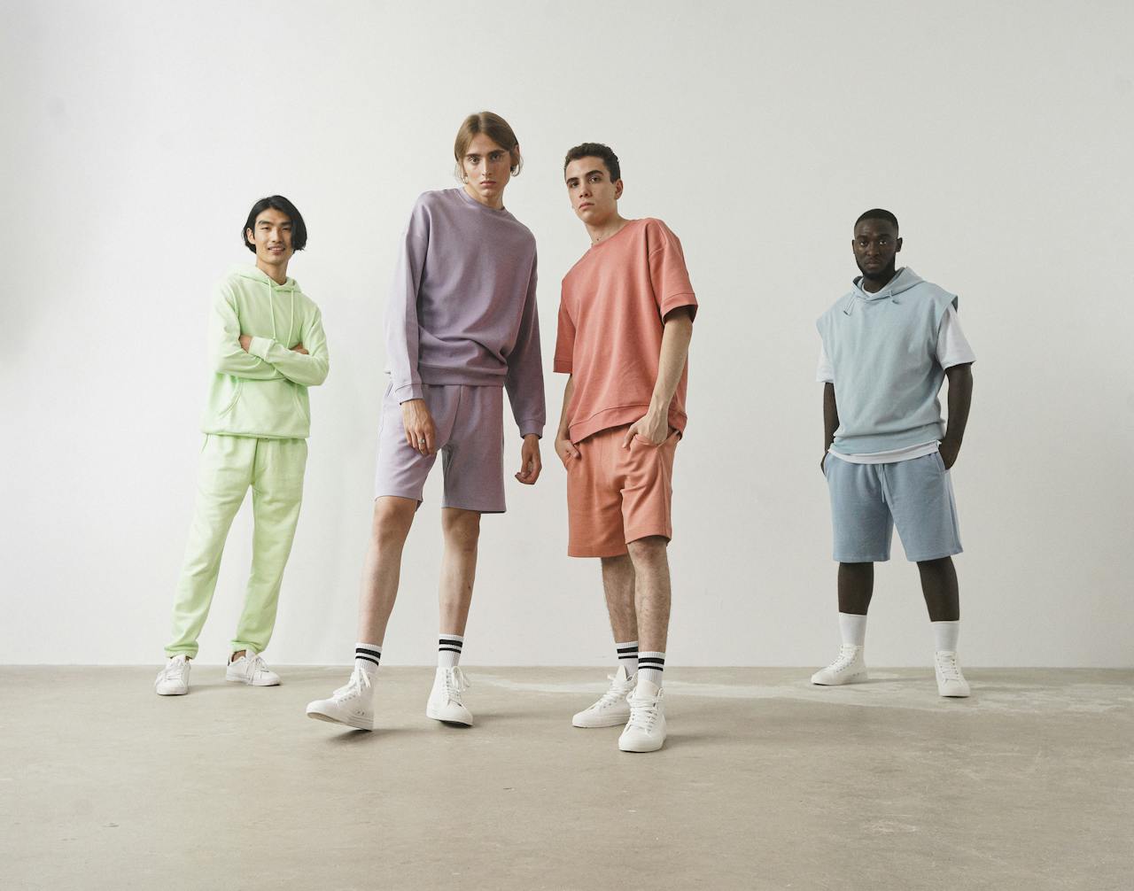 services-01 Stylish group of young models showcasing pastel casual wear in a minimalist setting.